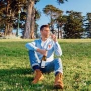 Kyle Legg, The Cosmopolitan Man, sipping Priest Ranch wine in San Francisco's Alamo Square Park.